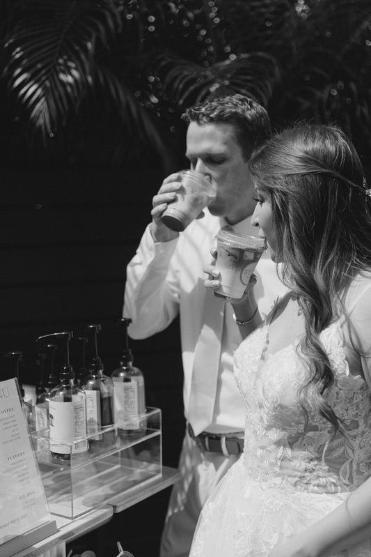 Wedding bride and groom drinking coffee from the coffee cart